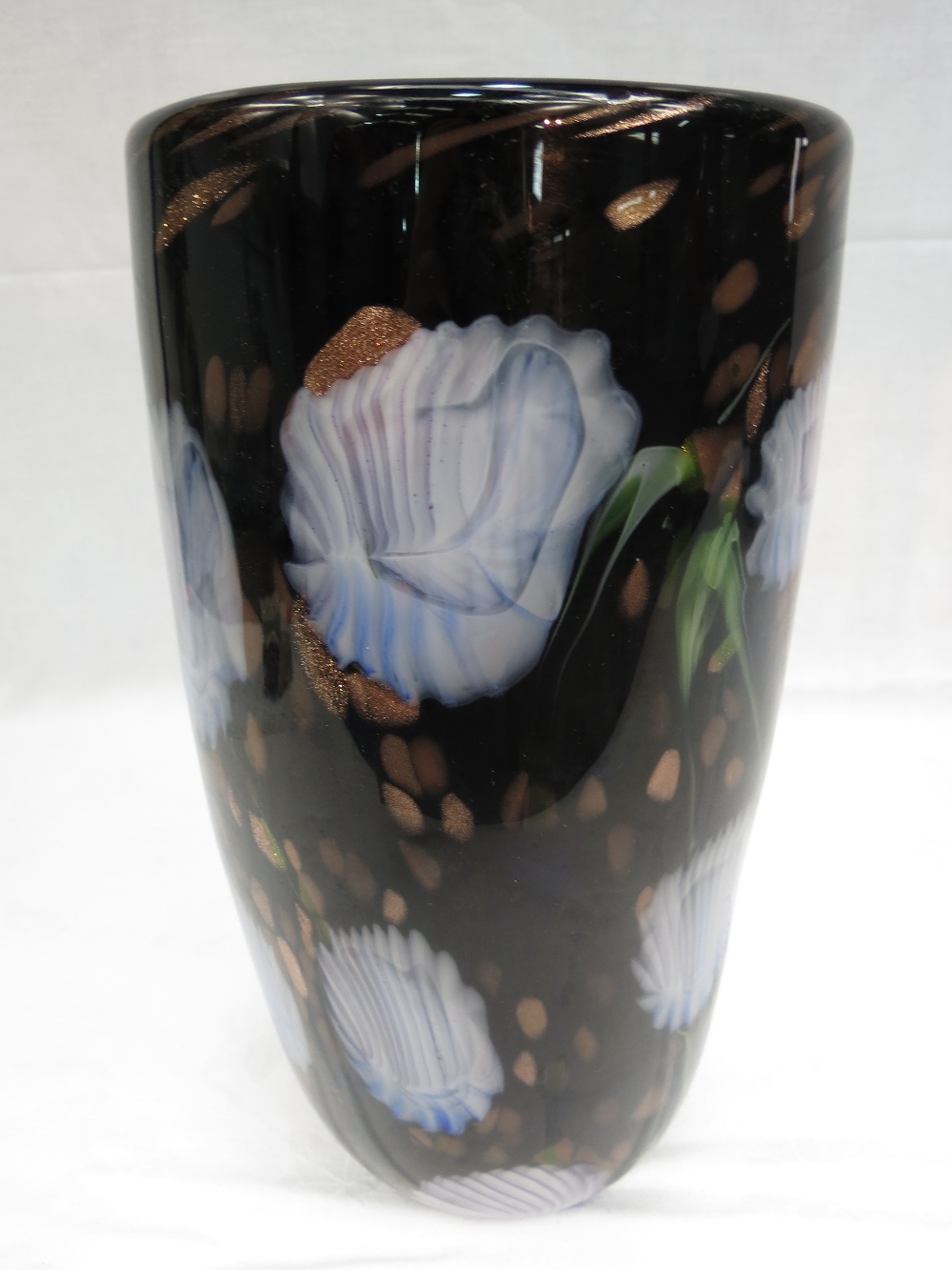 A black flower decorated cylindrical glass vase, 12" high.