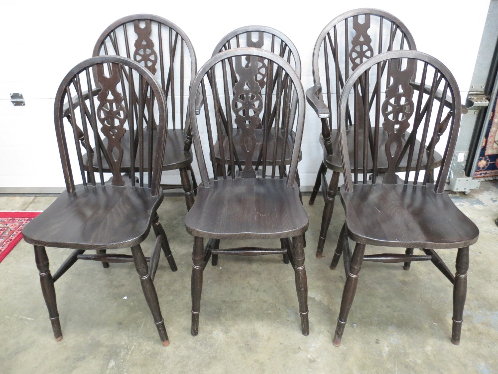 A set of six (four plus two) reproduction wheel back dining chairs, all raised over ring turned