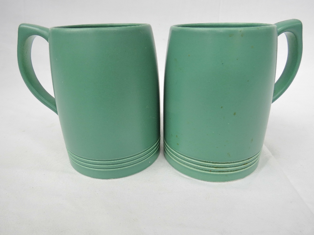 A pair of Keith Murray (1892-1981) designed green Wedgwood tankards. 5".