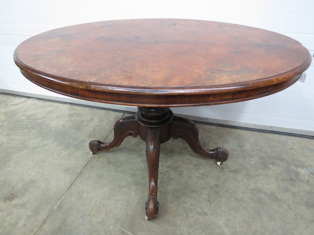 A good quality Victorian walnut oval tilt top table raised over short stem upon the quatro-form