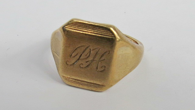 A 9ct signet ring, tablet head engraved PH. Weight 6.8g.