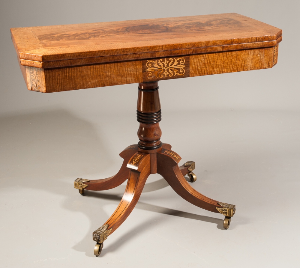 A Regency mahogany crossbanded and inlaid foldover card table, on turned column support and