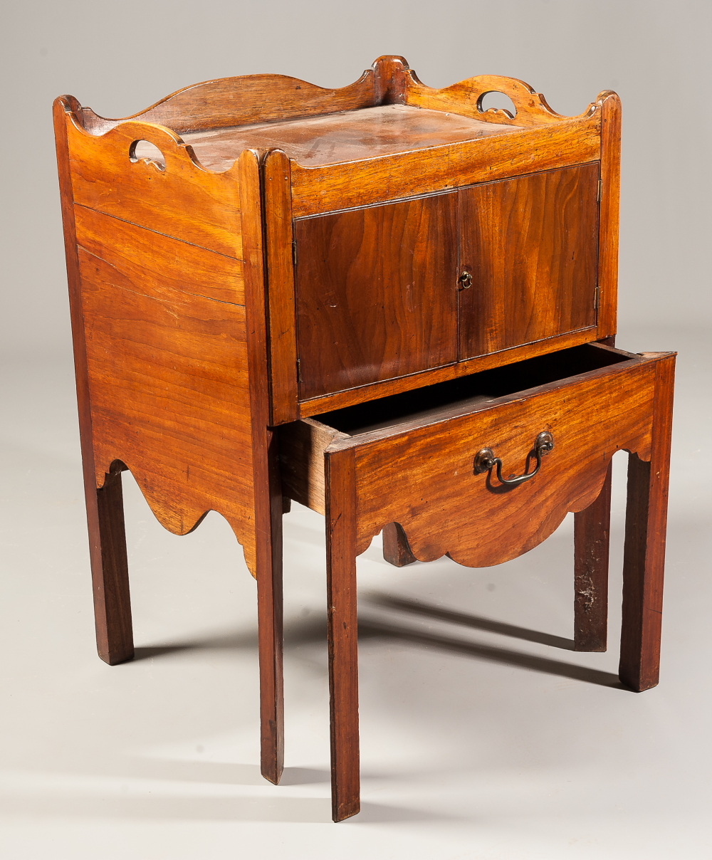 A George III mahogany tray top bedside cabinet, with shaped gallery and apron.