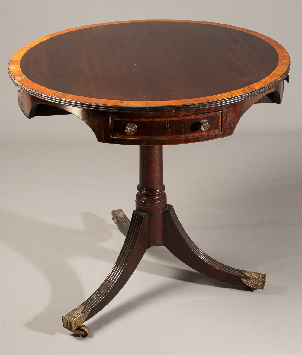 A mahogany and inlaid drum table in the Sheraton taste, the revolving crossbanded top with four