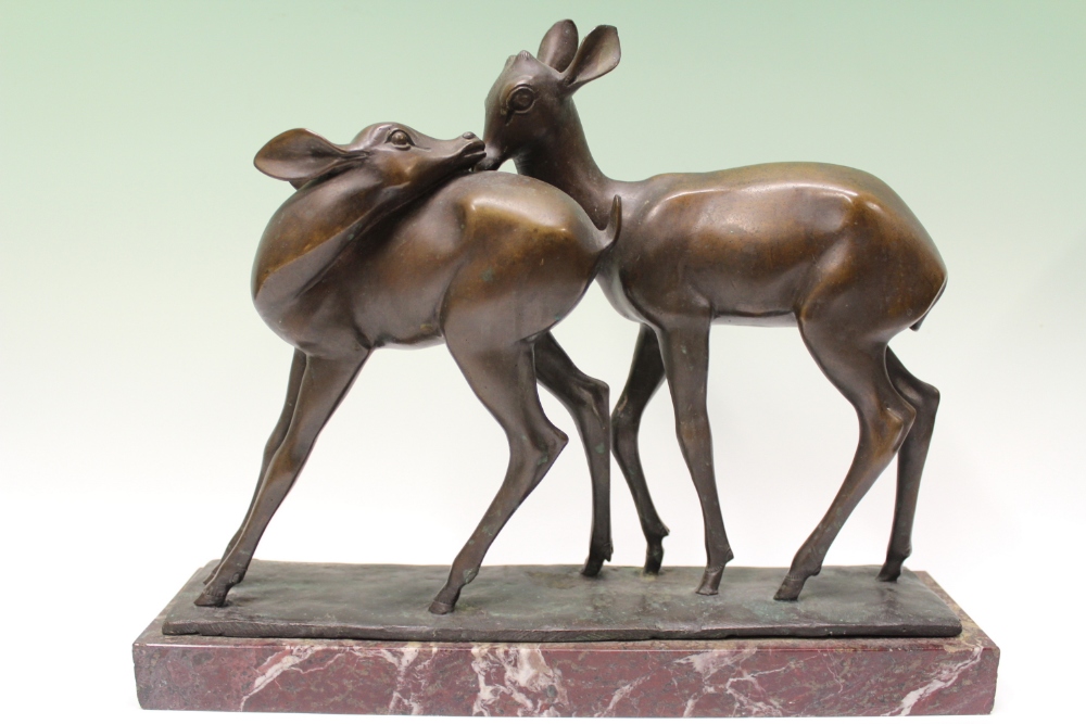 F. Martini (20th Century), an Art Deco bronze group of two deer, signed, 34cm, on rouge marble