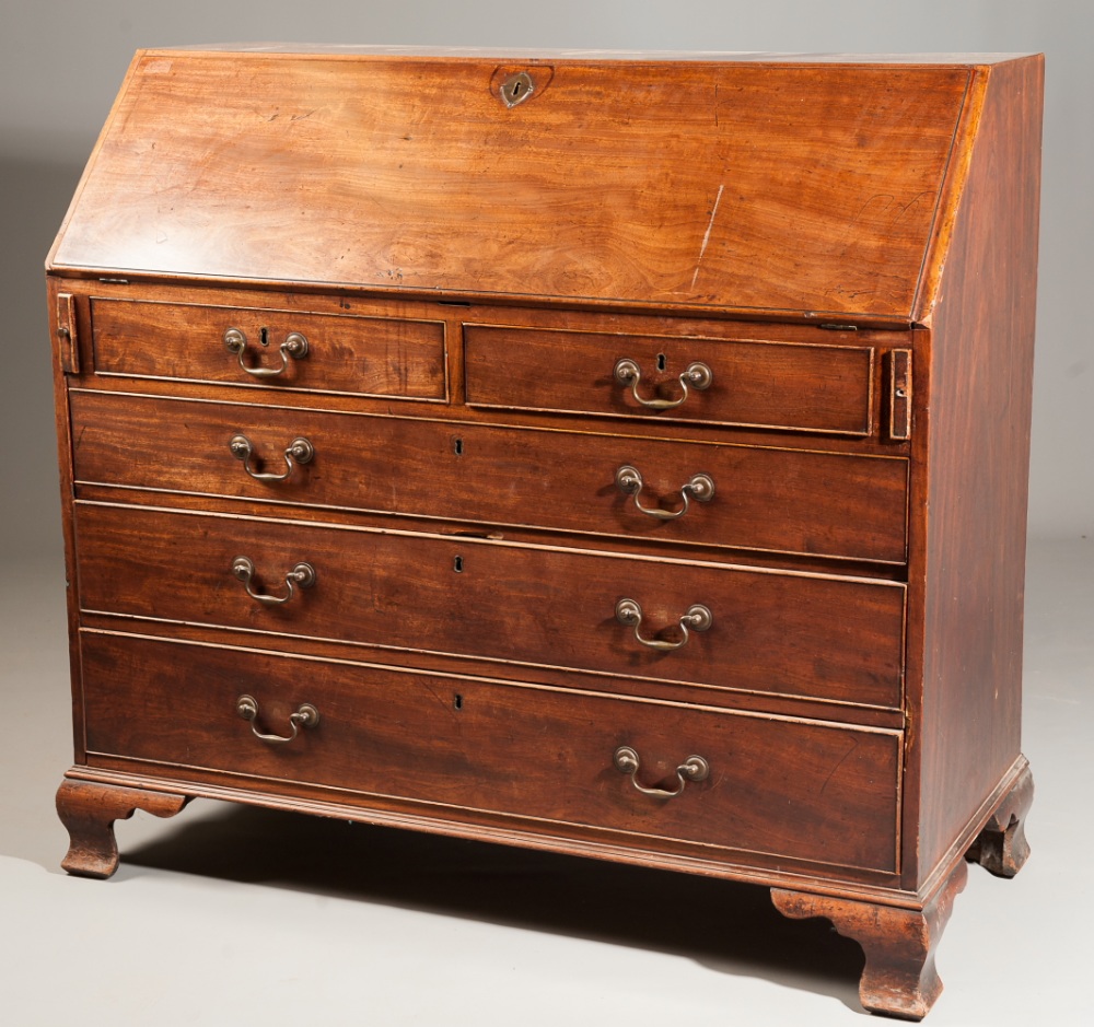 A large George III mahogany bureau, the fitted inlaid interior with many drawers, above two short