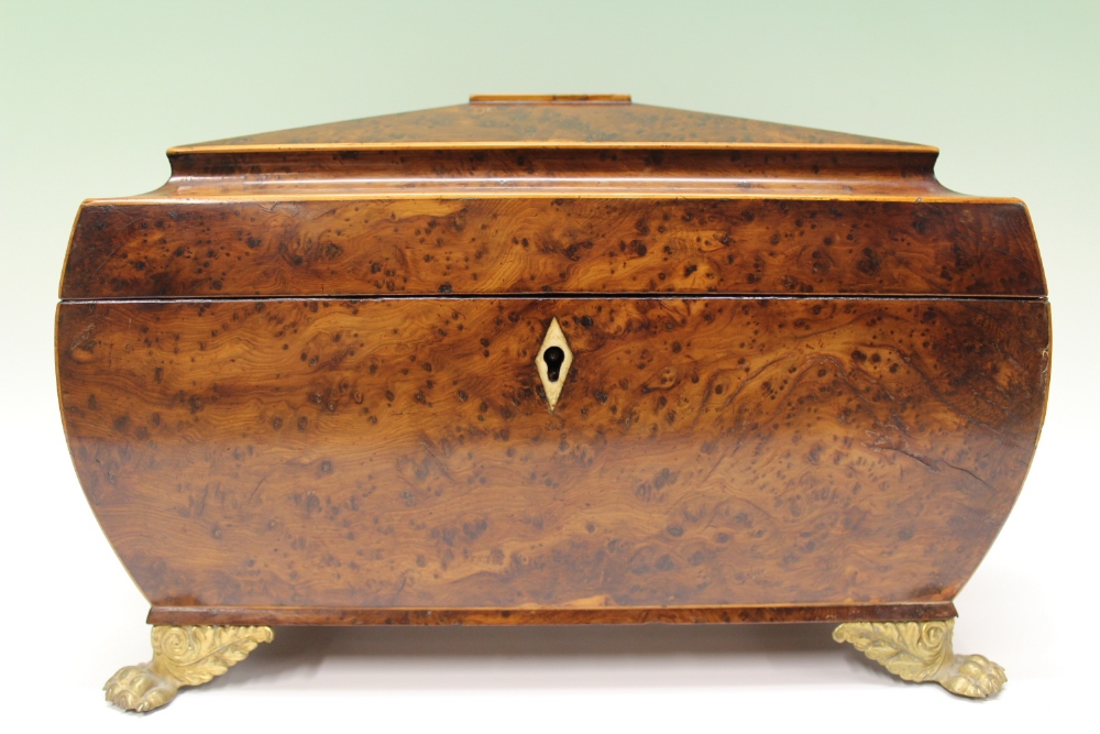 A large Regency gilt metal mounted and inlaid yewwood tea caddy, the fitted interior with mixing