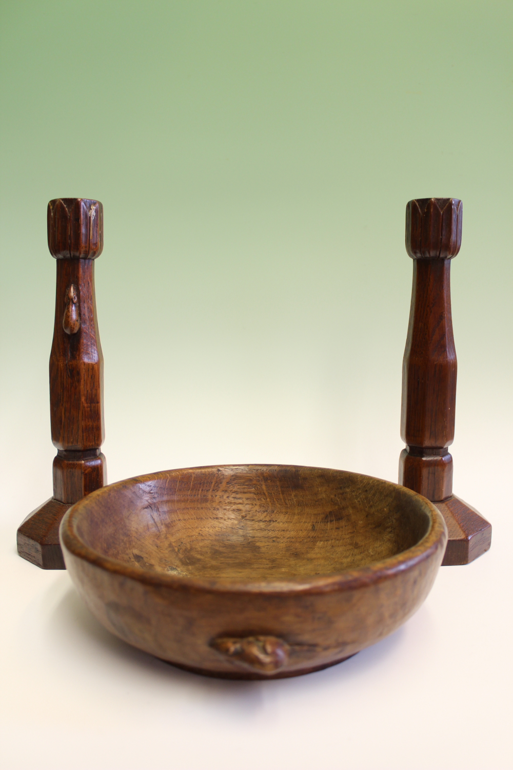 Robert Thompson "Mouseman": a pair of carved candlesticks, with stylized leaf tops and mouse