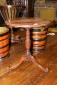 A miniature walnut tilt-top table, the circular moulded edge top on turned pedestal and trefid
