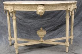 A Louis XVI style marble top console table, the shaped demi-lune top above carved and painted