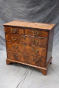 An 18th Century walnut and crossbanded chest of two short and three long drawers, on bracket feet,