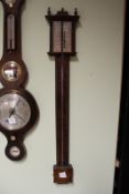 A stick mercury barometer, with silvered rectangular scale.