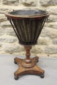 An early 19th Century mahogany and boxstrung jardiniere, with brass liner, on column support and