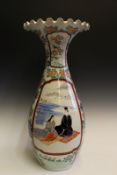 A large Japanese vase, decorated with two panels depicting courtly figures in a landscape, wavy rim,