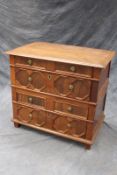 An 18th Century yew and oak two part chest of drawers, with panel sides and geometric moulding to