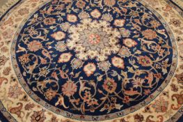 An Oriental circular rug of classic Persian design, 152cm diameter.