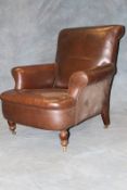 A Victorian deep seated Club armchair, with full hide brown leather upholstery, on short turned