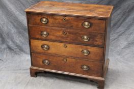A George III elm country made chest of four long graduated drawers, on bracket feet, 98cm wide.