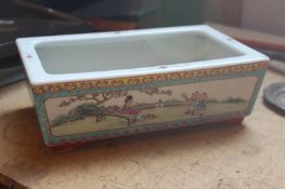 A Chinese famille rose rectangular jardiniere, with scenic panels.