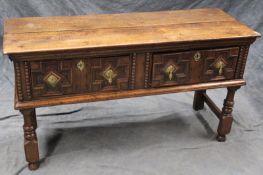 An oak two drawer dresser base, with panelled drawer fronts, on baluster turned front legs, 143cm