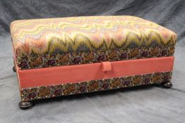 A Victorian box ottoman, on squat bun feet, the top with 17th Century style flame stitch tapestry