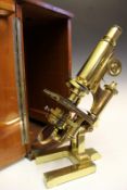 A late 19th Century brass monocular compound microscope, in mahogany case, the horseshoe base signed