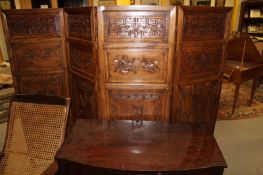 A Chinese carved six panel floor screen, each panel with five foliate and still life carved