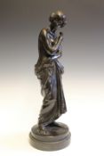 A bronze figure of a semi-draped young woman holding a rose, signed C. Cumberworth (Charles