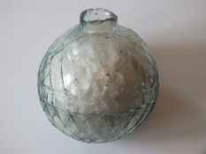 A green glass Target Ball, by N B Glassworks, Perth, containing white feathers.