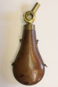 A Bosch type powder flask, the leather covered body with four sling mounts, the brass top with