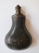 An early flat backed tin powder flask, of exaggerated pear form and with green painted finish.