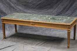 A Neoclassical style carved pine low table with inset marble top, above fluted frieze, and