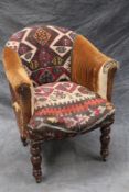 A late Victorian desk chair, with Kelim panel upholstery, on turned legs.