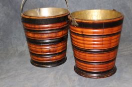 A pair of turned coopered buckets with brass liners and handles.