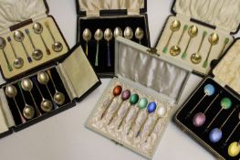 Six cased sets of six silver and enamel coffee spoons, comprising two matched Art Deco sets by