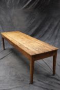 A 19th Century pine and fruitwood farmhouse kitchen table, the pine plank top above plain frieze, on