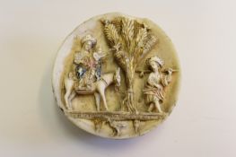 A 19th Century carved ivory hemisphere, the flat edge carved in relief with a scene of the Holy