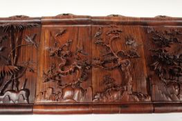 Four Chinese carved rosewood panels, each with landscape scenes of birds, flowers and foliage,