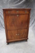 An early 19th Century mahogany escritoire, with marble top above frieze drawer, fall front writing