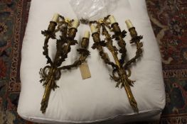 A pair of French ormolu three light wall sconces, with ribbon and floral entwined back plates, (