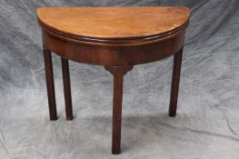 A late 18th Century mahogany triple top foldover tea/games/writing table, of demi-lune form, the