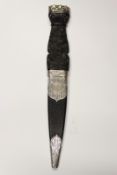 A silver mounted sgian dubh, 8cm flattened diamond section blade with faceted back edge,