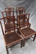 A set of six George III carved mahogany dining chairs, each with pierced Gothic revival back