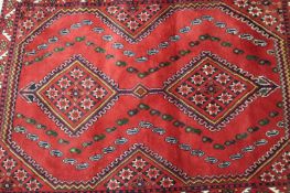 A Persian tribal rug and another of Bokhara design, the largest 183 x 125cm.