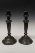 A pair of late George III pewter candlesticks.