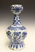 An early Delft vase, with onion top and floral and foliate decoration in blue on a white ground,
