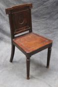 A late Victorian panel back hall chair.