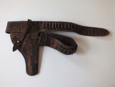 A Rattle Snake skin holster and belt, with provision for 32 rounds of ammunition.