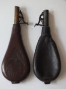 An embossed leather shot flask, decorated with a hunting scene, together with another with plain bag