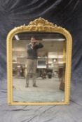 A Victorian later painted arch top overmantel mirror, the pierced crest with central shell, 160cm